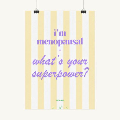 Hochformatiges Poster mit vertikalen pastellgelben und weißen Streifen. Der lila Text lautet "i'm menopausal - what's your superpower?". Am unteren Rand befindet sich der grüne Schriftzug "HOOHAA" mit kleinen pflanzlichen Illustrationen.
